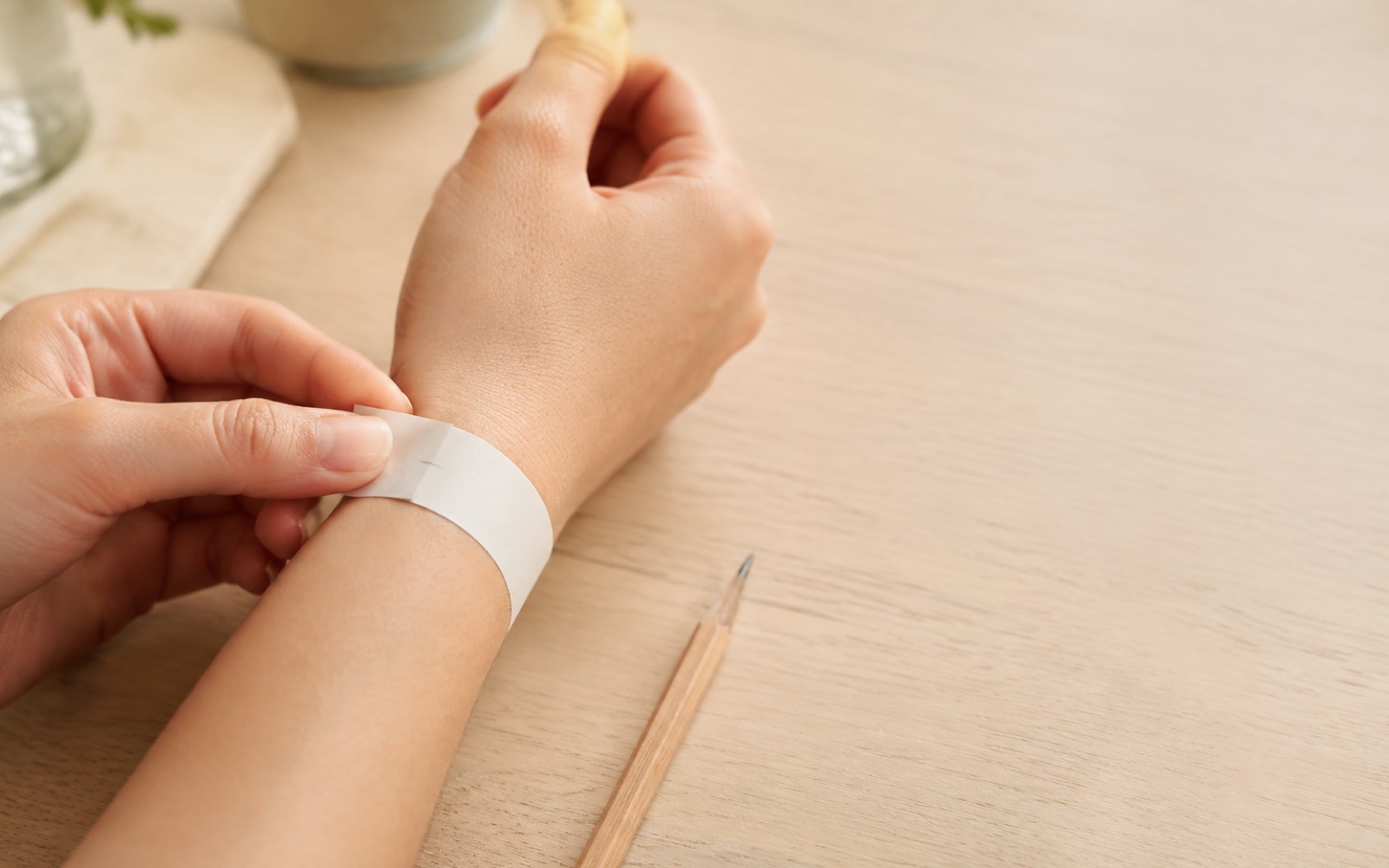 A wrist measured with a narrow paper strip and pencil mark