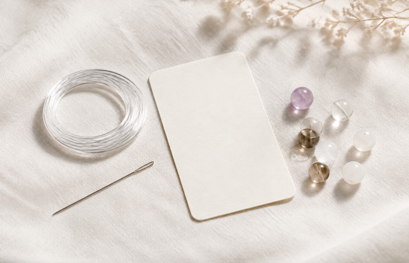Clear elastic cord, bead threader, instructions and spare beads